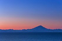 Mount Redoubt Volcano at sunrise, seen from Homer, Lake Clark National Park, Cook Inlet, Alaska, USA, March 2013.