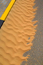 Sand patterns at curb of road, curb, Dubai, United Arab Emirates.