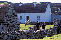 Farmers by stone wall in Aran Islands, Republic of Ireland.