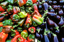 Peppers (Capsicum annuum) and Aubergines (Solanum melongena) at market stall, Aix-en-Provence, France.