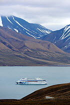 Ferry on Isfjorden with Svalbard Global Seed Vault visible in the corner of the landscape, Svalbard, Norway, July 2012.