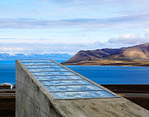 Svalbard Global Seed Vault with facade designed by artist Dyveke Sanne, and coast, Svalbard, Norway, July 2012.