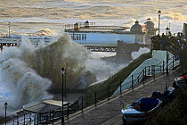 High waves lashing Cromer seafront and pier during storm surge., Norfolk, England, UK. December 2013.