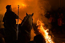 Man on horse taking part in the Luminarias festival, when riders jump through fire to purify their horses, held every January in San Bartolome de Pinares, Avila Province, Castile and Leon, Spain, Janu...