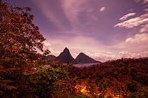 View of the Pitons at night during full moon, Gros and Petit Piton, from Anse Chastenet, Saint Lucia. April 2014.