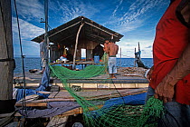 Miskito Indian fishermen preparing gill net, Puerto Cabezas, Nicaragua, Caribbean Sea. Model released.