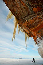 Jagged icicles hanging from towering sandstone cliff, Apostle Islands National Lakeshore, Lake Superior, Squaw Bay, Wisconsin, February 2014.