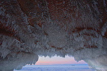 Icicles hanging from sandstone ceiling of sea cave on frozen lake. Apostle Islands National Lakeshore, Lake Superior, Squaw Bay, Wisconsin, January 2014. Exposure composite of 3 images.