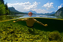 Split-level image of man swimming in Altausseer lake. Austria, July 2013.