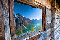 Reflection of Geirangerfjorden and Sunnylvsfjorden in a window of a mountain hut at Blomberg (452m). More og Romsdal, Norway. May 2012
