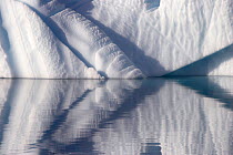 Sculptural shapes of an iceberg, reflected in the Arctic Ocean, East Greenland.