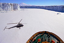 Icebreaker 'K. Khlebnikov' with helicopter and the Cambell Ice Tongue, Terra Nova Bay, Antarctica.