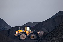 Digger moving coal between heaps. Yorkshire, UK, January 2014.