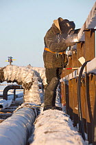 A welder working outside at -32 Celsius in Sabetta, South Tambey Gas field, Yamal, Siberia, Russia. February 2014.