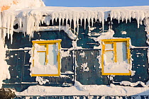 An old, snow covered wooden accommodation building in Sabetta, South Tambey Gas field, Yamal, Siberia, Russia. February 2014.