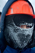 A gas field worker wearing protective clothing with frosted breath at -30 Celsius in the South Tambey Gas Field, Yamal Peninsula, Siberia, Russia. February 2014.