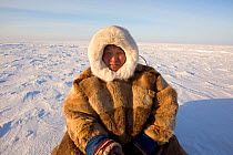 Jakov Vanuito, a Nenets reindeer herder, resting during a  snowmobile journey across the tundra in the South Tambey Gas Field, Yamal Peninsula, Siberia, Russia. February 2014.