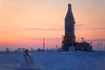 A gas drilling derrick at sunset in the South Tambey Gas Field, Yamal Peninsula, Siberia, Russia. February 2014.