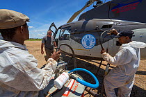Helicopter is refuelled for Food and Agriculture Organization (FAO) locust control operation. Miandrivazo Airport, Madagascar December 2013.