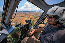 Food and Agriculture Organization (FAO) helicopter pilot Eric Gadot, an expert at locust control operations flying over effected area, near Miandrivazo, Madagascar. December 2013.