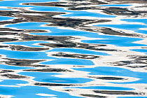 Reflections of clouds in ripples of sea water, Svalbard, Norway,  June 2010.