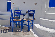 Blue table and chairs in the shade, Santorini / Thira Island, Greece.