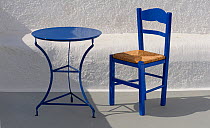 Blue table and chair in the shade,  Santorini / Thira Island, Greece.