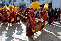 Buddhist monks playing long trumpets (Lawa) during Torgya festival. Galdan Namge Lhatse Monastery, Tawang, Arunachal Pradesh, India. January 2014.