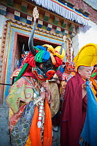 Monks and dancers walk in procession out of the monastery with the 'Cake' (containing all the evil) to be burned at the end of the first day of the Torgya festival. Galdan Namge Lhatse Monastery,Tawan...