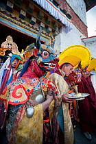 Monks and dancers walk in procession out of the monastery with the 'Cake' (containing all the evil) to be burned at the end of the first day of the Torgya festival. Galdan Namge Lhatse Monastery,Tawan...