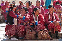 Ladies in traditional Monpa tribe dress (typical head dress made from Yak hair) during Torgya festival. Galdan Namge Lhatse Monastery,Tawang, Arunachal Pradesh, India. January 2014.