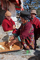 Vender with Yak butter during the Torgya festival. Galdan Namge Lhatse Monastery, Tawang, Arunachal Pradesh, India. January 2014.