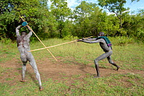 'Donga' stick fighters, Suri / Surma tribe. The Donga fights are an outlet to resolve conflicts between tribes. Omo river Valley, Ethiopia, September 2014.