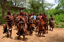Women dancing in traditional clothing during the Ukuli ceremony, a rite of passage for boys to become men. Hamer tribe, Omo river valley, Ethiopia, September 2014.