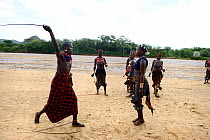 During the Ukuli ceremony and before the bull jumping, the Maza (young initiated men) whip the Hamer women who will defy them, showing no fear or signs of pain. Hamer tribe, Omo river Valley, Ethiopia...