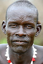 Portrait of Topoza man with traditional scaring. Topoza tribe, Omo river Valley, Ethiopia, September 2014.