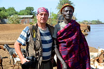 Photographer Eric Baccega with Dasanetch man on Omo river bank. Omorate, Omo river Valley, Ethiopia, September 2014.