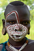 Young Suri / Surma woman with painted face. Omo river Valley, Ethiopia, September 2014.