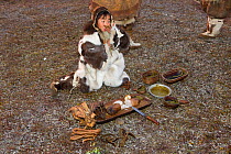 Young girl Nadia Takui eating specially prepared ritual food, including dried reindeer intestine and a sausage made from chopped reindeer meat and fat, during the Chukchi  'Festival of the Young Reind...