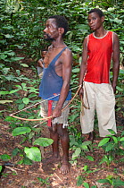 Mbuti Pygmy men with bows and arrows for hunting, Democratic Republic of the Congo, Africa, November 2011.