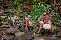 Mbuti Pygmy men resting and looking around whilst hunting, Ituri Rainforest, Democratic Republic of the Congo, Africa, November 2011.