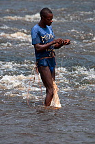 Fisherman with net on Ituri River, Bomili Village, Ituri forest, December 2011.