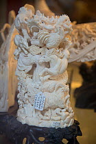 Carved Forest elephant (Loxodonta cyclotis) ivory tusks, for sale in shop on Nathan Road, Kowloon, Hong Kong, December 2012. This is identified as Forest elephant ivory by the pink tinge.