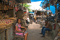 Woman selling rugs at Matche de la Volier (Market of the Thieves), Kinshasa, Democratic Republic of the Congo, March 2012.