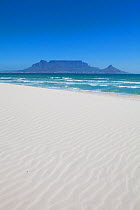 Pristine white beach with table mountain beyond under a clear blue sky. Bloubergstrand, Cape Town, South Africa. November 2011.
