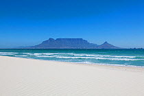 Pristine white beach with table mountain beyond under a clear blue sky. Bloubergstrand, Cape Town, South Africa. November 2011.