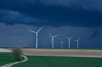 Wind farm under dark clouds before a storm, Ribemont, Picardy, France, April 2014.