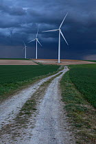 Wind farm under dark clouds before a storm, Ribemont, Picardy, France, April 2014.