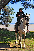 Park ranger on horseback next to the Guadalquivir river, Donana National Park, Andalusia, Spain, March 2014.