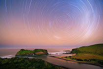 Two hour star trail over Hole in the Wall. Wild Coast, Eastern Cape, South Africa. May 2013. Non-ex.